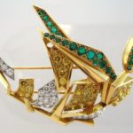 Cartier Gold & Platinum White & Yellow Round Diamond & Emerald Figural Brooch. Sold For $22,500.