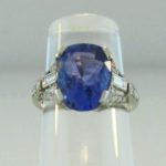 Cushion Sapphire, Round & Baguette Diamond Platinum Ring. Sold For $6,562.