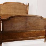 Louis XVI Style Wood And Cane Queen Bed. Sold For $11,250