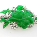 Platinum And Diamond Brooch With Floral Carved Jadeite. Sold For $6,125.