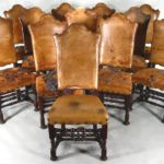 Set Of 12 Walnut Highback Leather Dining Chairs, Early 20th C. In The 17th C. Style. Sold For $20,400.